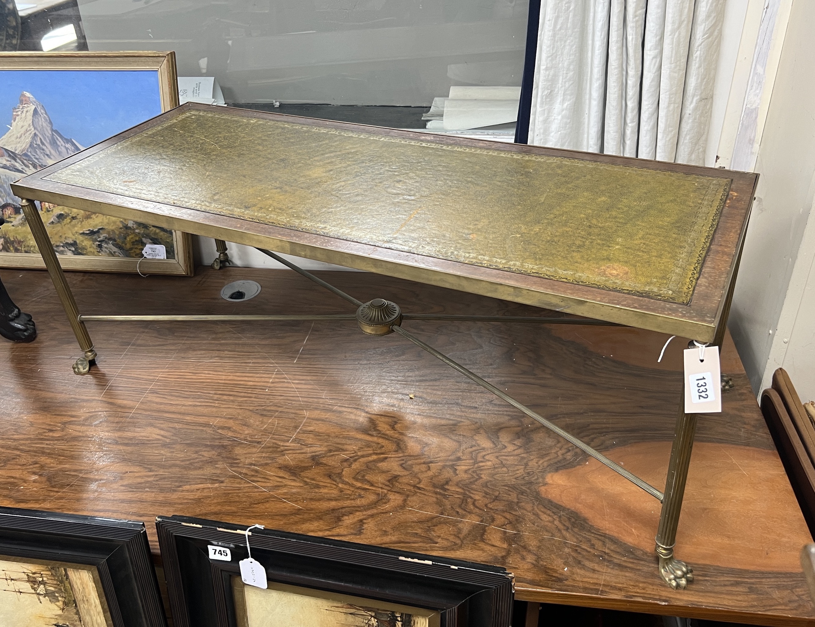 A mid century rectangular brass and mahogany leather topped coffee table with lion paw feet, width 107cm, depth 44cm, height 38cm